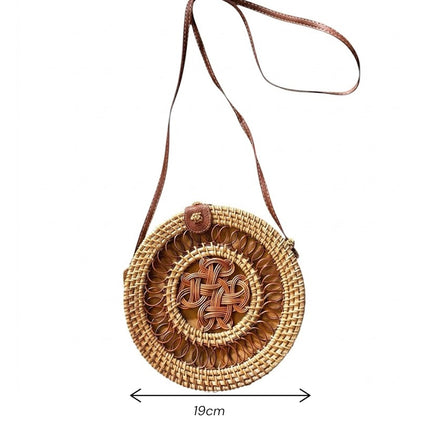 Cute vintage handwoven round rattan crossbody bag with natural handicraft style and adjustable size details.