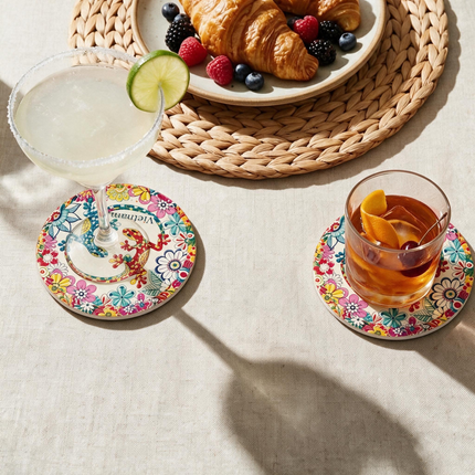 This round ceramic coaster provides a practical resting place for your coffee mug while showcasing playful salamanders and intricate floral patterns.