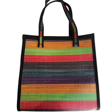 Handwoven colorful seagrass tote bag with rainbow stripes.