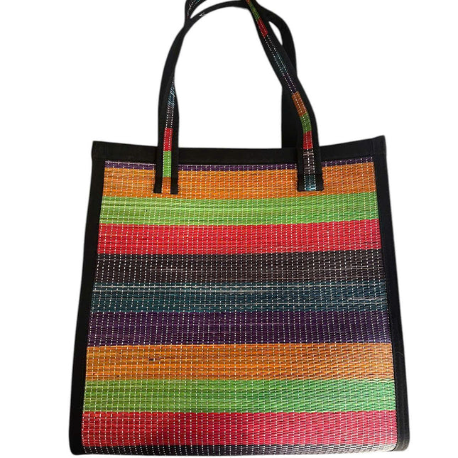 Handwoven colorful seagrass tote bag with rainbow stripes.