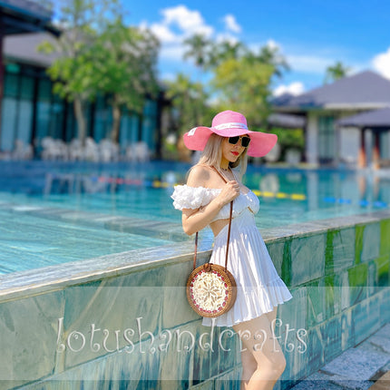 Lovely round rattan crossbody bag with elegant mother of pearl inlay.