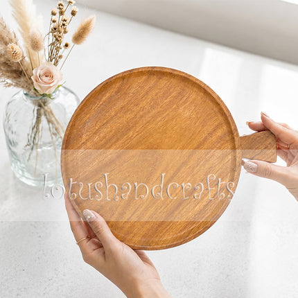 The small round ashwood serving tray with a handle is designed for extremely high durability.