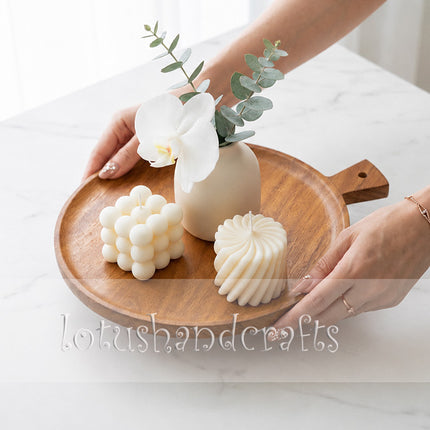 A small round ashwood serving tray with a handle is highly versatile for everyday use.