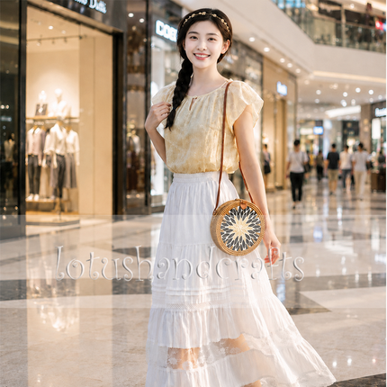 Round woven rattan wicker straw crossbody purse with mother of pearl accents that attracts attention.