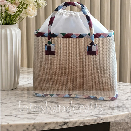 Captivating woven seagrass tote bag with painted daisy design.
