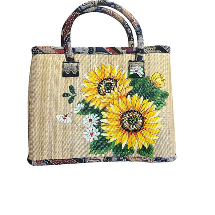 Handmade woven seagrass tote bag featuring a cute vibrant sunflower design.