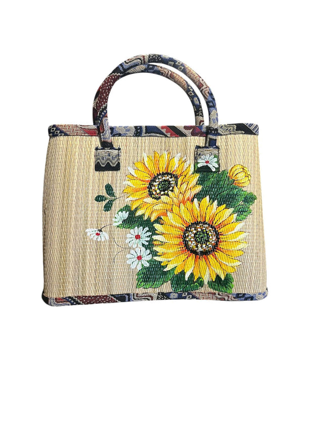 Handmade woven seagrass tote bag featuring a cute vibrant sunflower design.