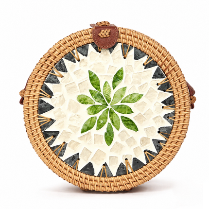 This cute round rattan crossbody bag features a mother of pearl leaf mosaic and leather strap.