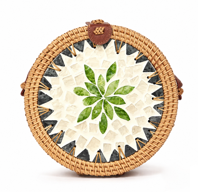 This cute round rattan crossbody bag features a mother of pearl leaf mosaic and leather strap.