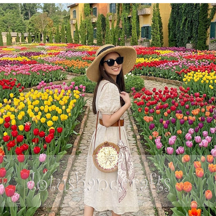 Lovely round rattan crossbody bag with eye-catching mother of pearl inlay.