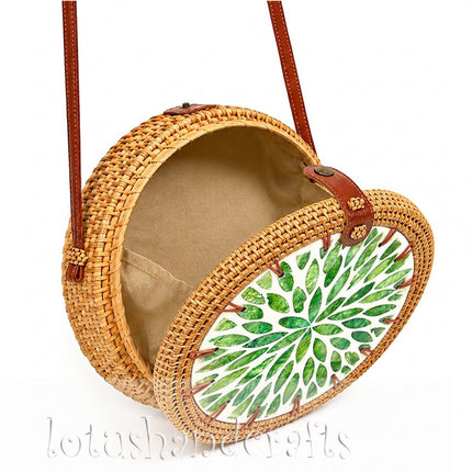 Youthful boho round rattan crossbody bag with green leaf mother of pearl inlay.