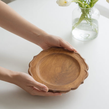 Handcrafted scalloped wood charger plate made from natural wood for elegant table styling.