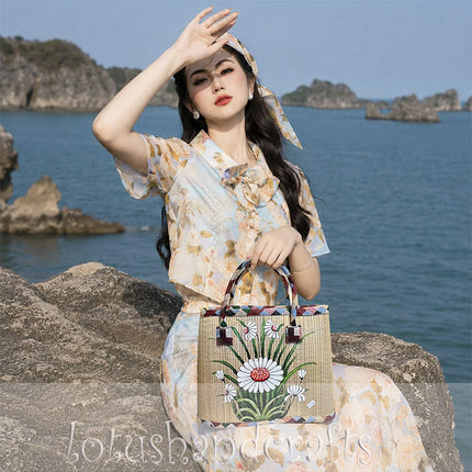 Handmade seagrass tote bag with a hand-painted white daisy garden.