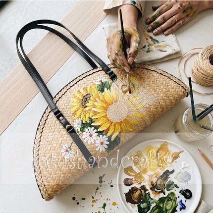 The woven grass half moon bag with sunflowers easily draws attention wherever you go.