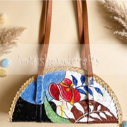 This eco friendly woven grass half moon bag showcases a beautifully painted lady design.