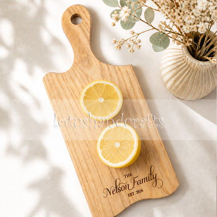 Ash wood serving board with handle for cutting and serving food beautifully.
