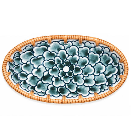 Rich dark blue blossoms and delicate blue-green shading create an elegant botanical pattern across the white ceramic surface.