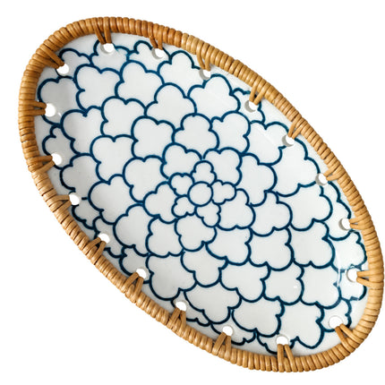 Elegant blue floral pattern radiating beautifully from the center of the oval ceramic tray.