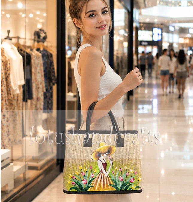 Handwoven seagrass tote bag featuring a charming hand-painted girl in a tulip garden.