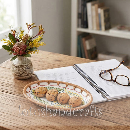 Decorative oval rattan tray showcasing a charming botanical pattern, ideal for serving coffee-time treats, biscuits, chocolates, nuts, or small fruits.