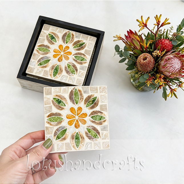 Lifestyle setup showcasing several square mother-of-pearl coasters neatly displayed on a modern wooden coffee table.