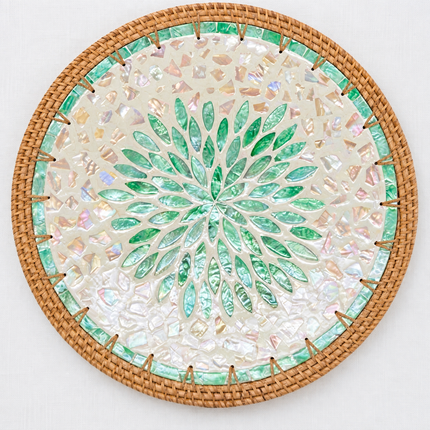 Handcrafted round placemat featuring a mesmerizing emerald green leaf burst pattern radiating from the center.