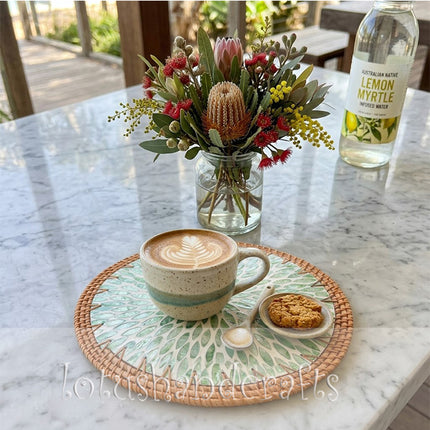 Round rattan placemat with shimmering green mother of pearl leaf inlay by Lotushandcraft.