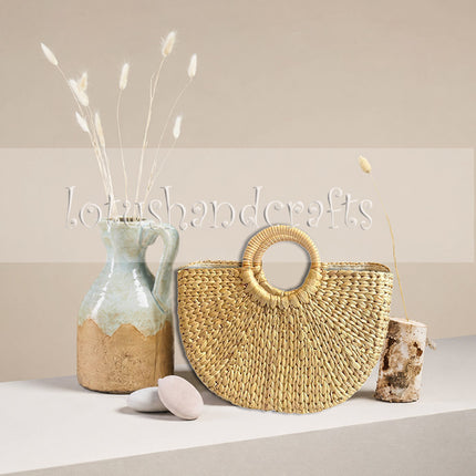 Handwoven half moon seagrass tote bag with round handles and stylish design.