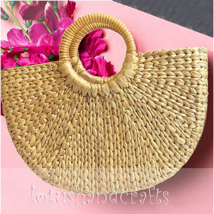 Handwoven half moon seagrass tote bag with elegant round handles.