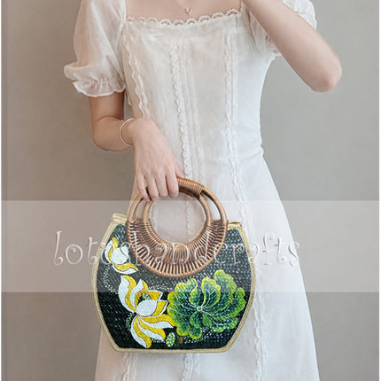 Handwoven seagrass rattan bag with hand painted lotus blossom and seashell design.