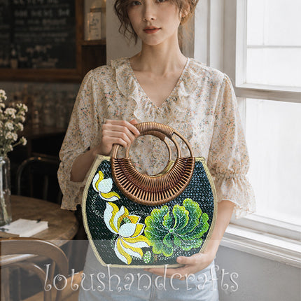 Handwoven seagrass rattan bag with hand painted lotus blossom design.