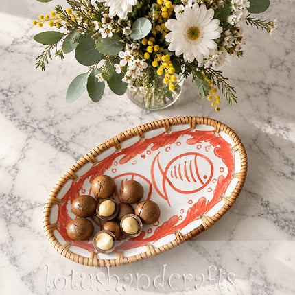 Delicate red lines and curved fish details create a distinctive nautical-inspired artwork.