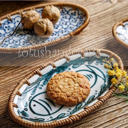 Elegant handmade ceramic tray with twin teal fish design displayed as coastal home decor on a wooden table.