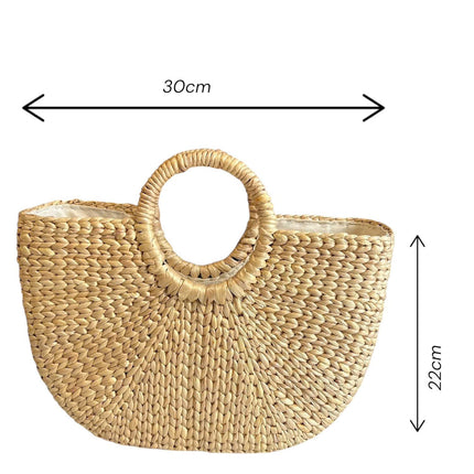 Handwoven half moon seagrass tote bag for the beach.