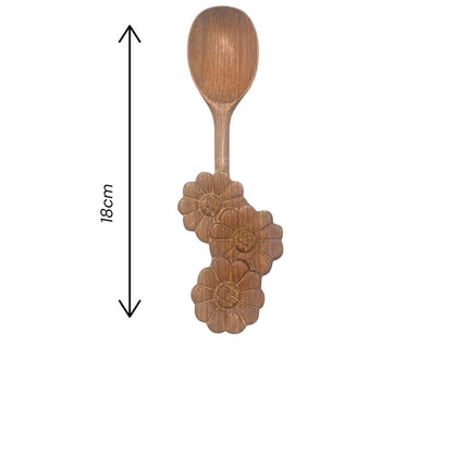 A handcrafted wooden spoon with a beautiful three flower handle design adds elegance and charm to your kitchen decor.