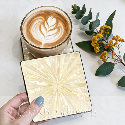Radiant sun-inspired mother of pearl coasters that bring coastal charm and sophisticated beauty to everyday table settings.