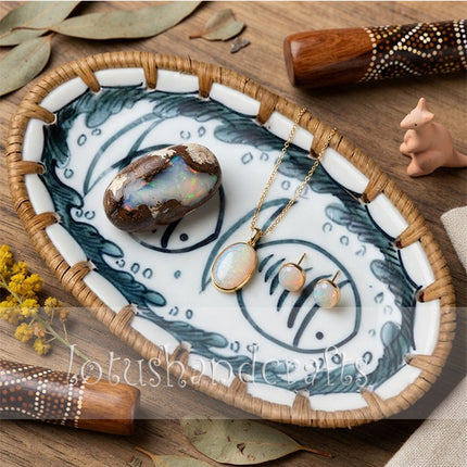 Decorative oval ceramic tray with woven rattan edge styled for jewelry, candles, and everyday home accessories.