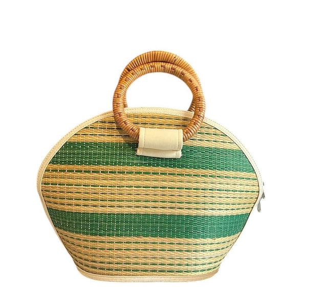 Handmade seagrass straw handbag with rattan handle in a half moon shape.