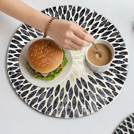 Handcrafted Round Mother of Pearl Placemat featuring a Black and White Leaf Mosaic Pattern.