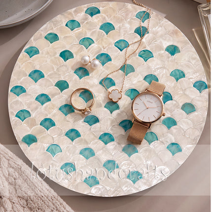 Round mother of pearl placemat with turquoise fish scale mosaic.