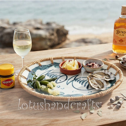 Artisan-crafted ceramic tray by Lotushandcrafts featuring a peaceful twin fish motif and warm natural rattan frame.
