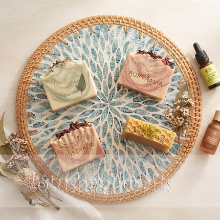 Detailed view of turquoise and blue mother of pearl inlays arranged in a graceful leaf mosaic design on a natural rattan placemat.
