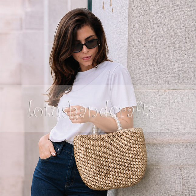 Handwoven water hyacinth tote bag with beautiful pearl handles.