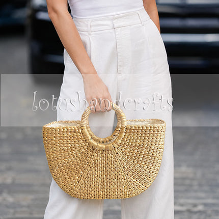 Handwoven half moon seagrass beach tote for effortless style.
