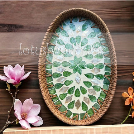 Stylish handwoven oval rattan tray featuring a green leaf mother of pearl mosaic inlay.