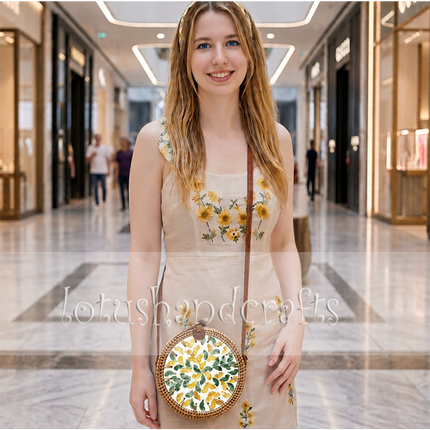 Round rattan crossbody bag featuring a green and yellow mother of pearl leaf inlay.