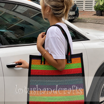 Handwoven seagrass tote bag with colorful rainbow. 