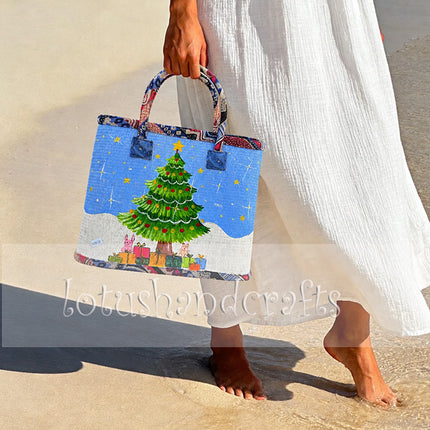 Handmade woven seagrass tote bag with painted Christmas tree design and charming appeal.