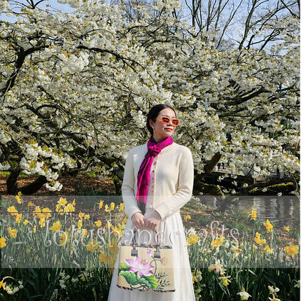 Handmade woven seagrass tote bag featuring a beautifully hand-painted lotus blossom.