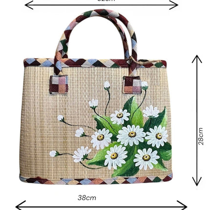 Handwoven seagrass tote bag with a hand painted white daisy bouquet size.